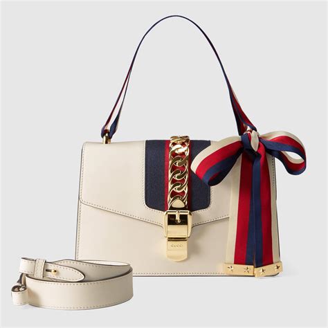 white bone spur gucci shoulder bag with stripe crossbody strap|Gucci crossbody jewelry.